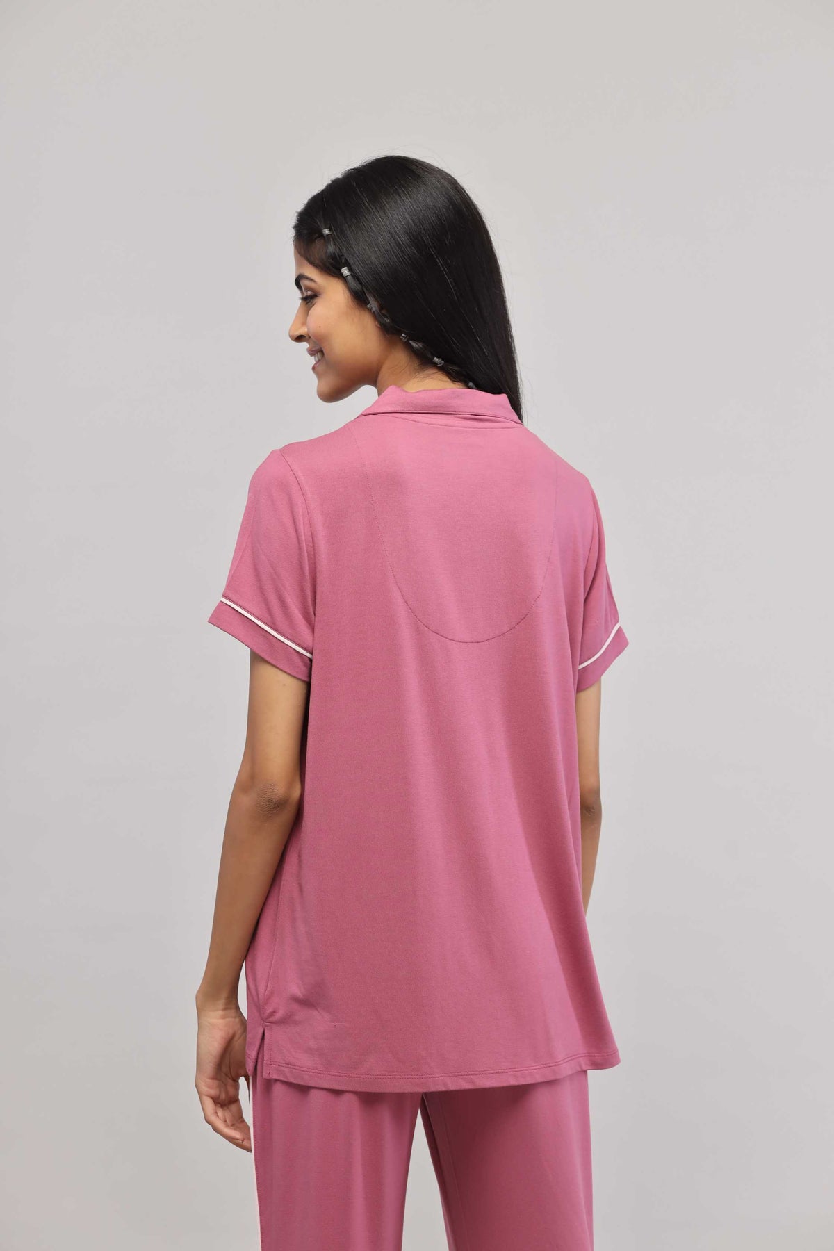 Rosy pink half sleeve top with button down and piping details.