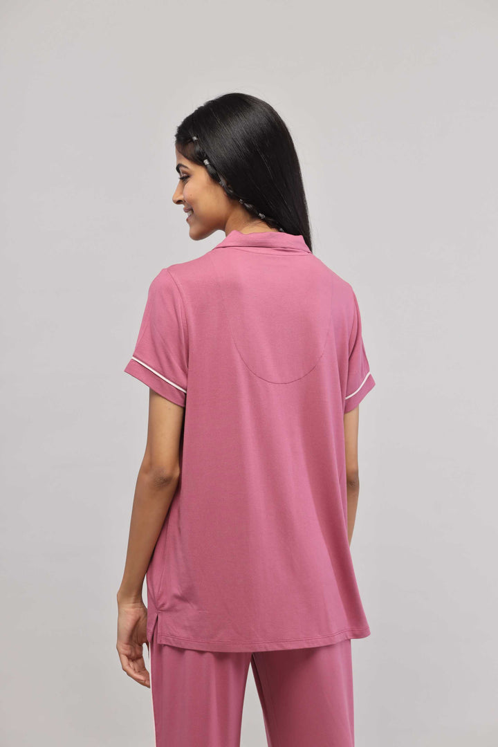 Rosy pink half sleeve top with button down and piping details.
