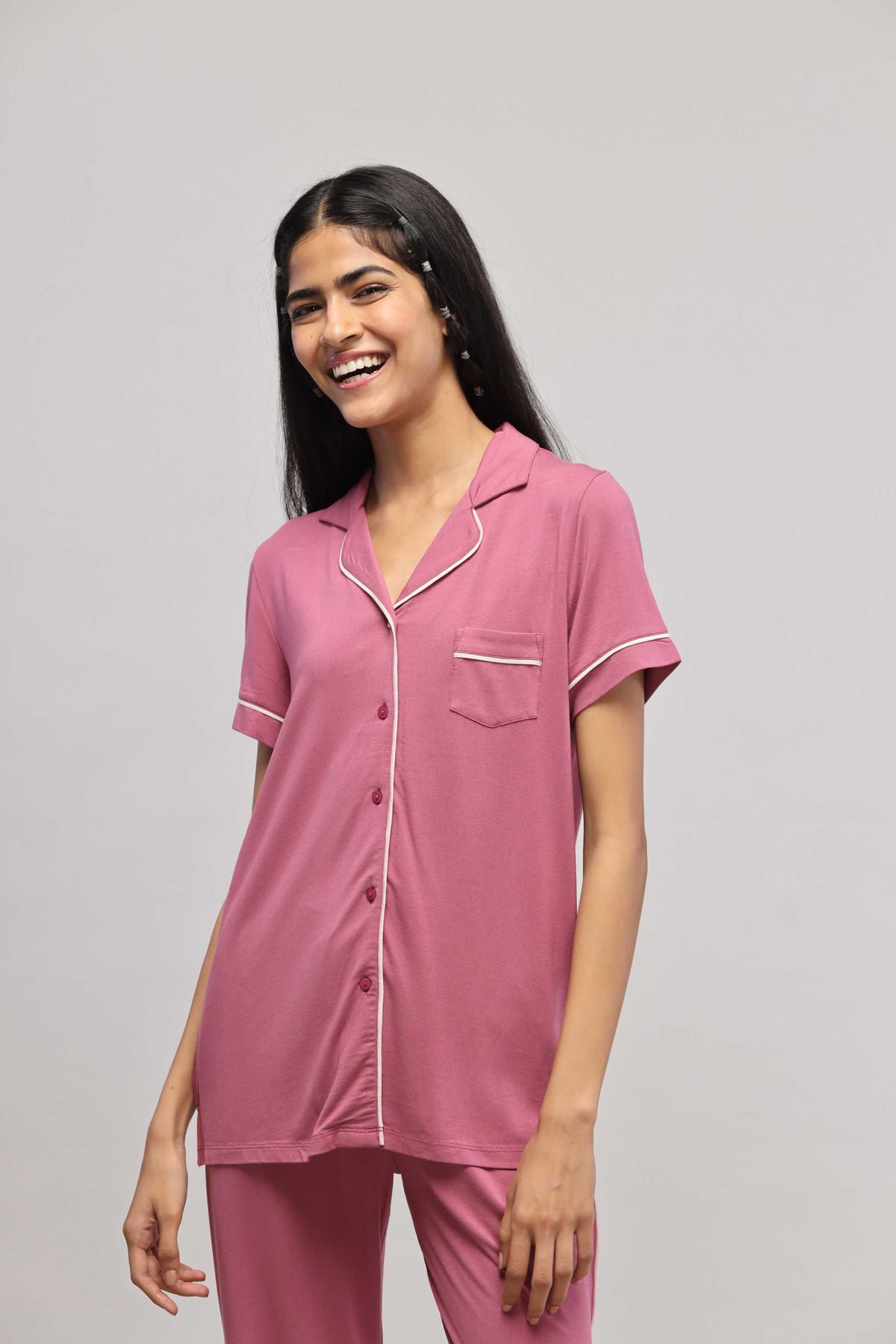 Rosy pink button-down top with half sleeves and piping detail.