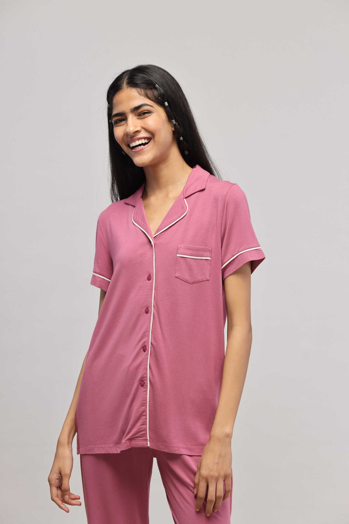 Rosy pink button-down top with half sleeves and piping detail.