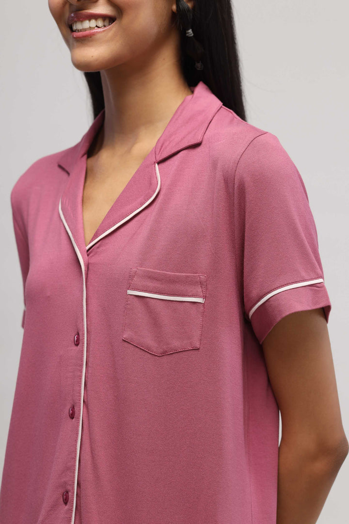 Rosy pink half sleeve top with piping detail and pocket.