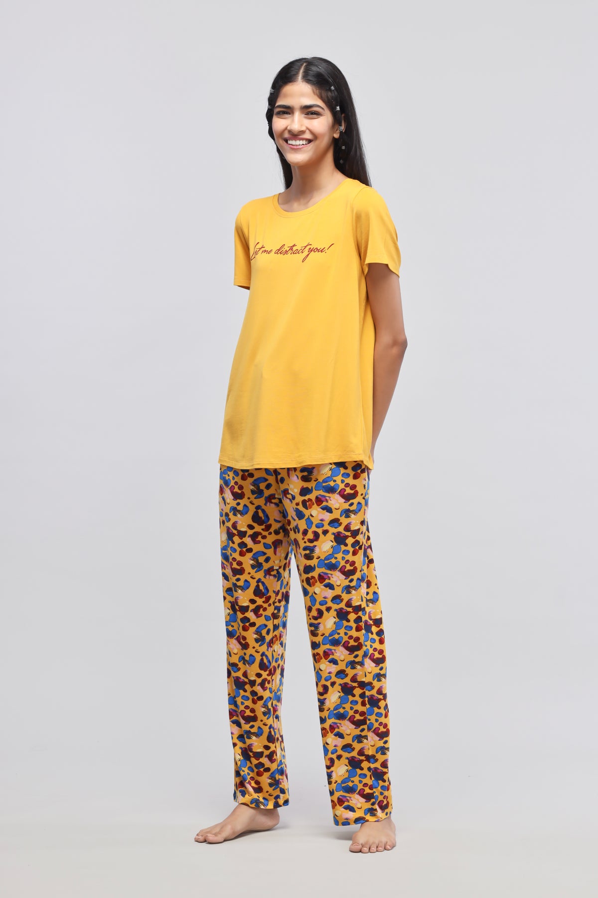 Stylish woman wearing Safari Modal Pajamas in vibrant colors.