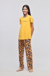 Stylish woman wearing Safari Modal Pajamas in vibrant colors.