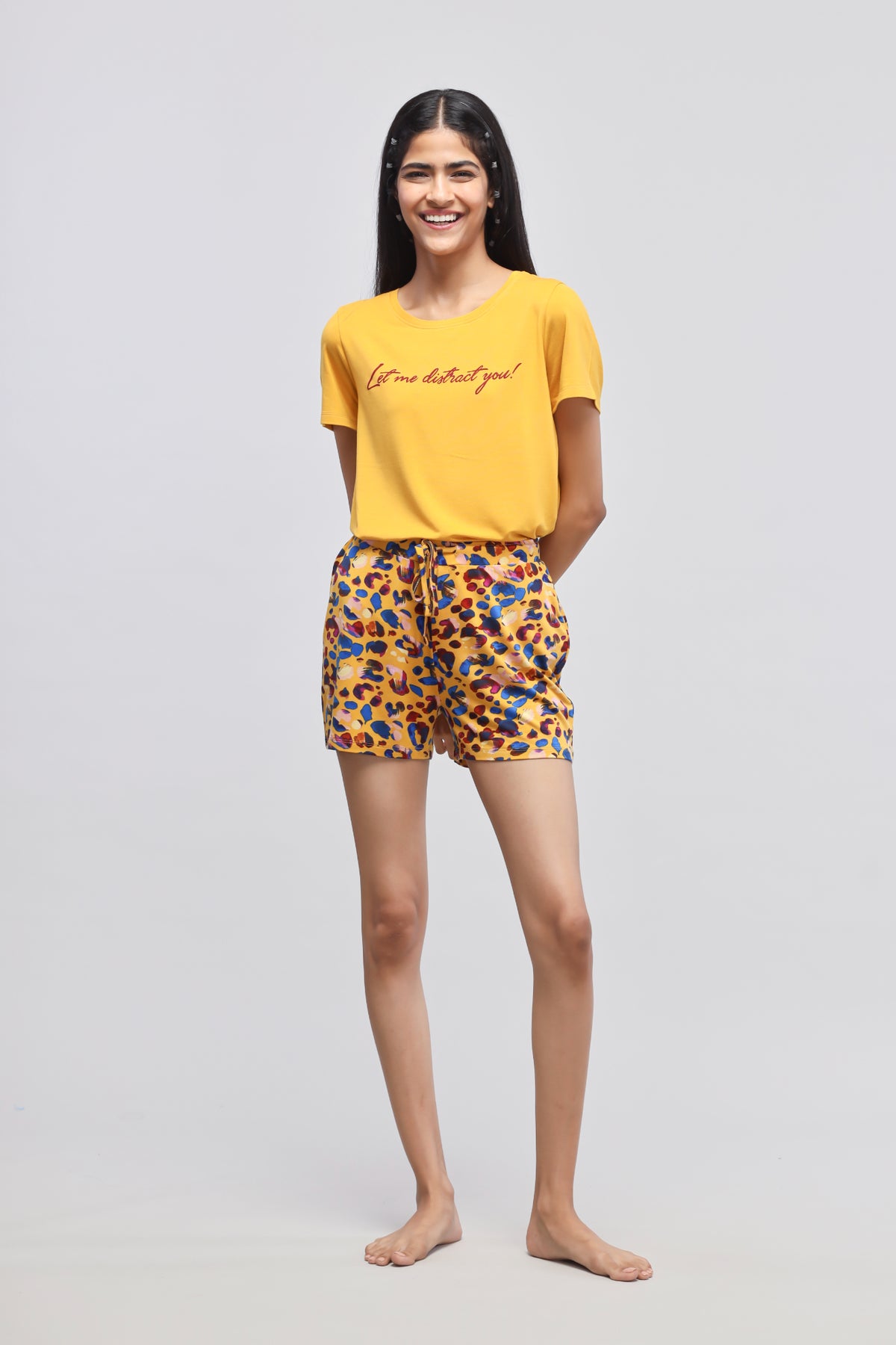 Stylish woman wearing Safari Modal Shorts and yellow tee.