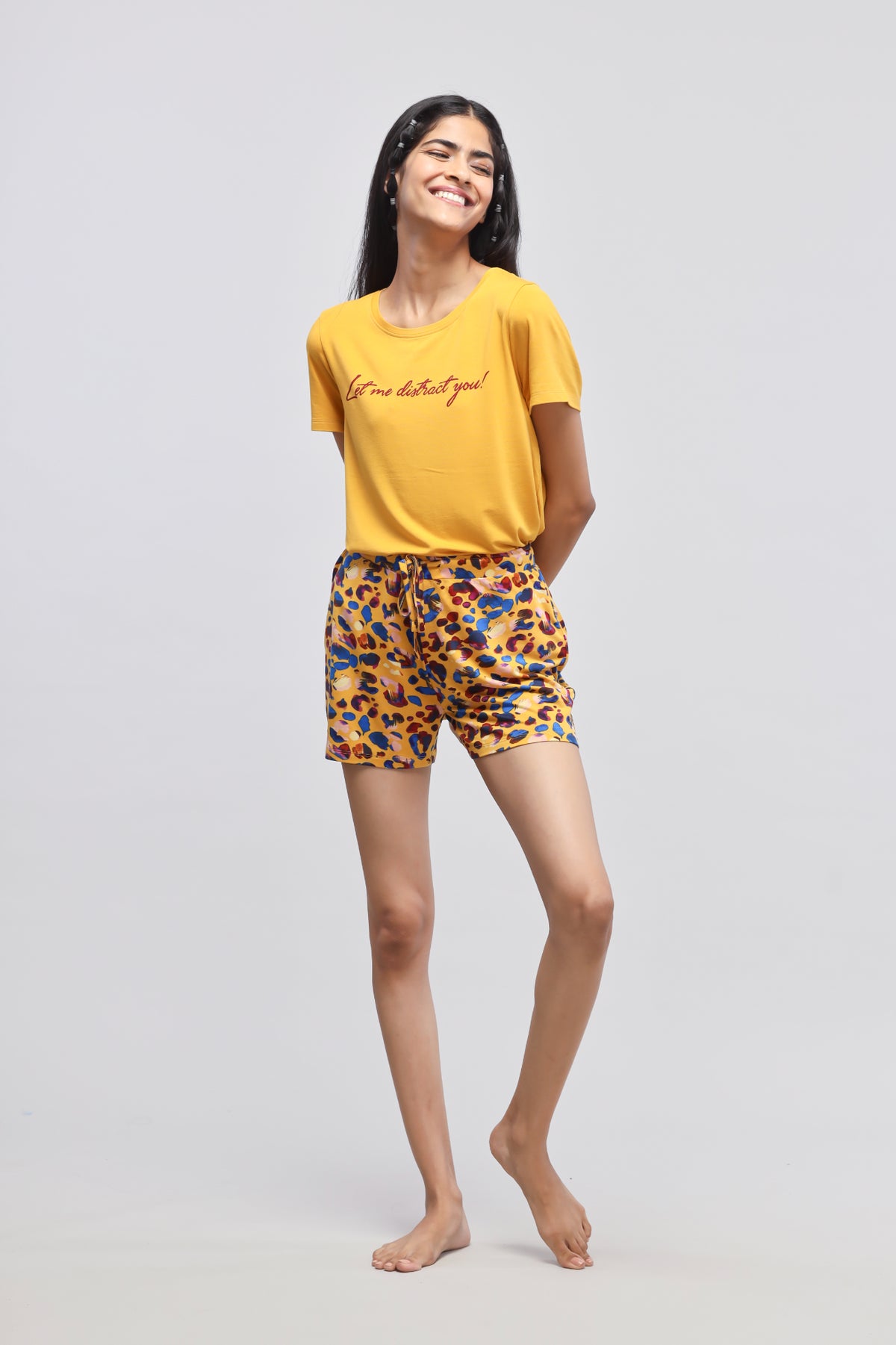 Smiling model wearing Safari Modal Shorts and yellow graphic tee.