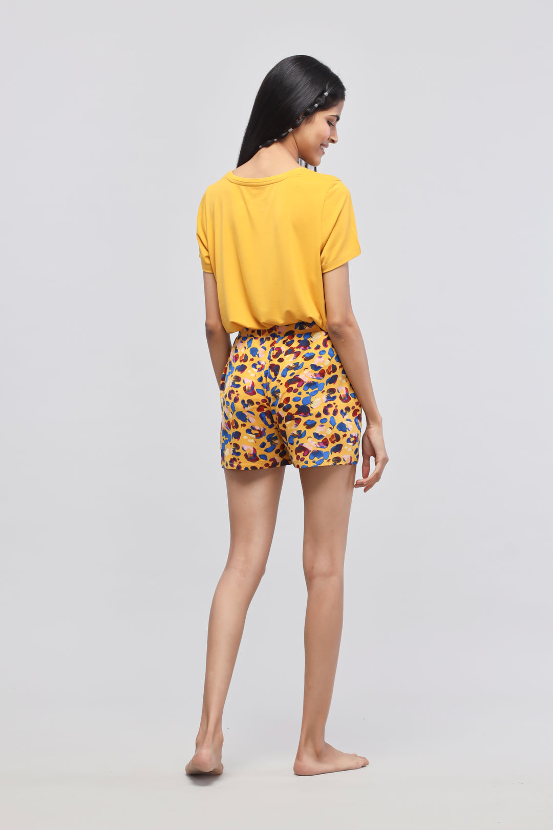 Model wearing Safari Modal Shorts Set in vibrant yellow and leopard print.