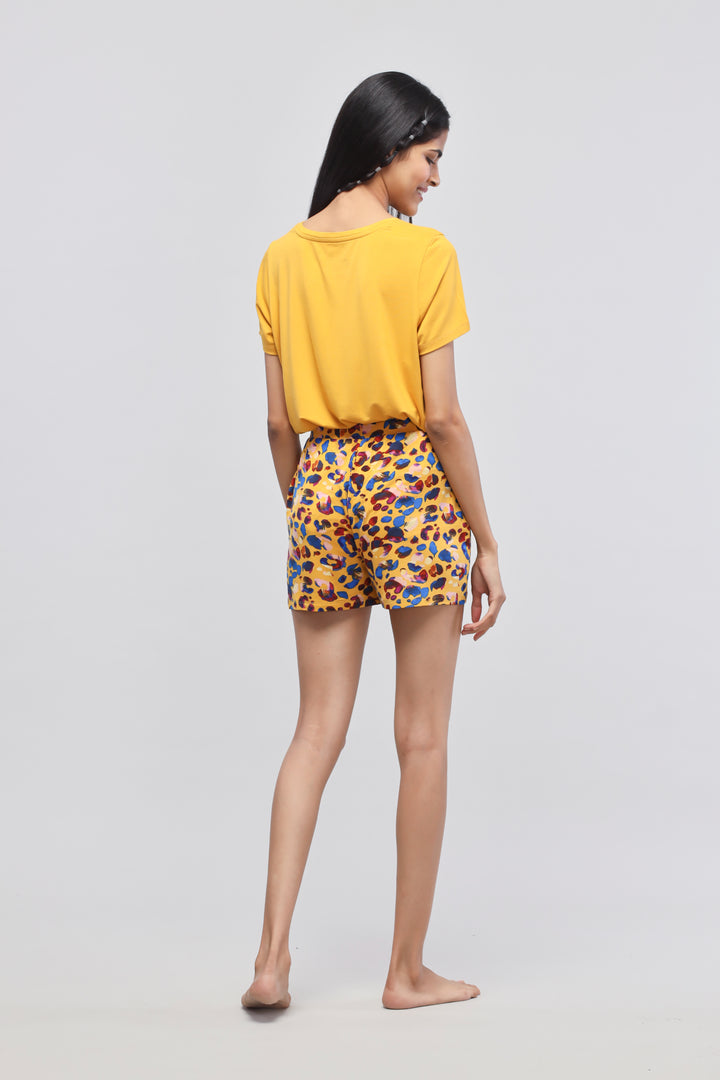 Model wearing Safari Modal Shorts Set in vibrant yellow and leopard print.