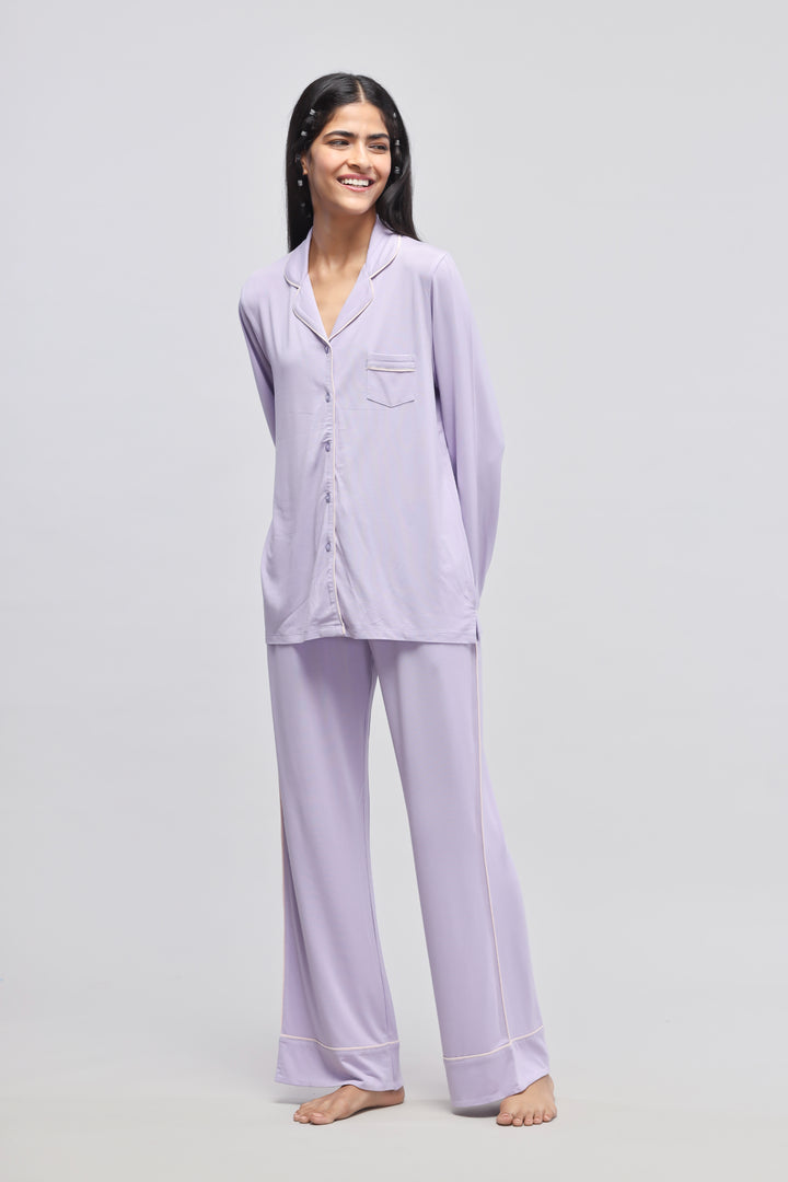 Lavender piping pajamas showcased on a smiling model.