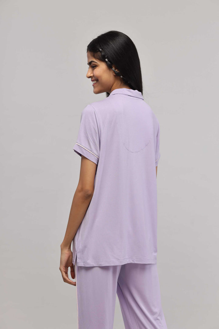 Lavender button-down half sleeve top with piping, back view.