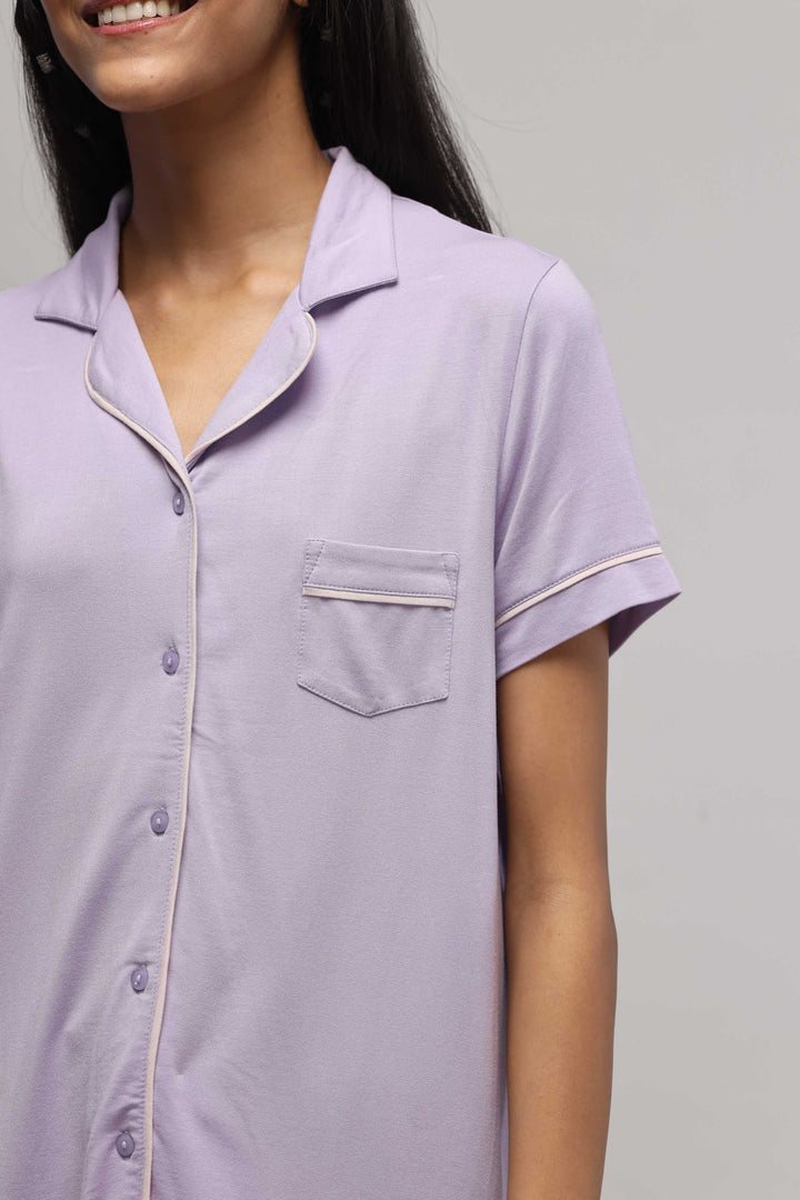 Lavender button down half sleeve top with piping details.