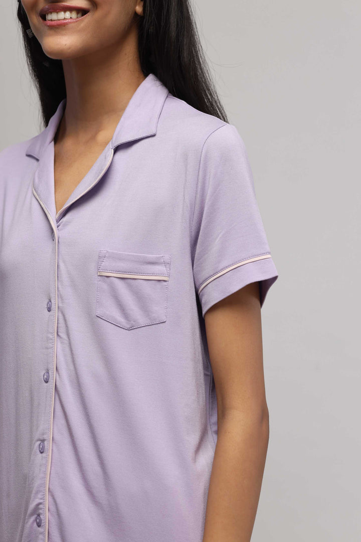 Lavender button down half sleeve top with piping detail.