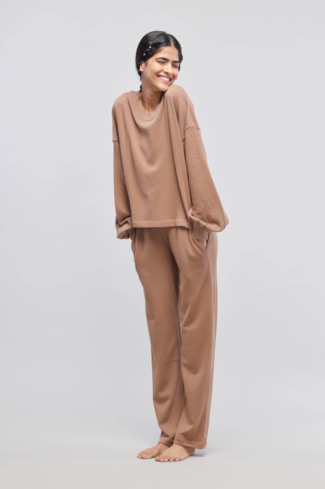 Brown terry puffed sweatshirt model smiling, casual comfortable outfit.