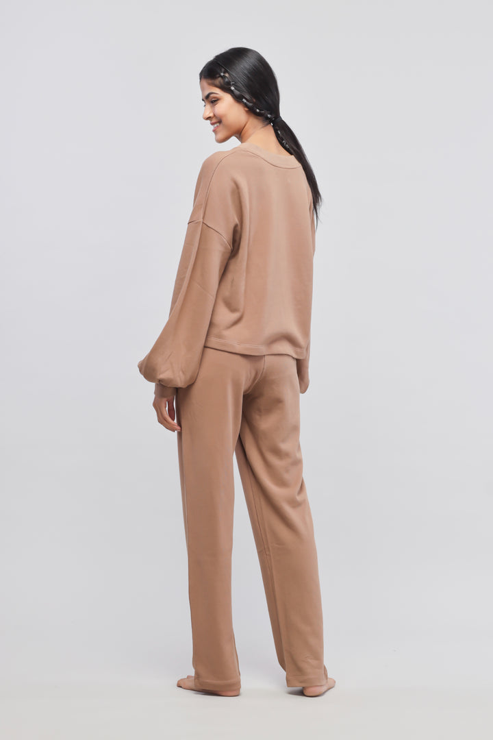 Brown terry puffed sweatshirt worn with matching pants, stylish and cozy.