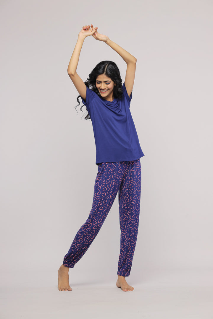 Cheerful woman in Blue Heart Pajama Set, dancing joyfully.
