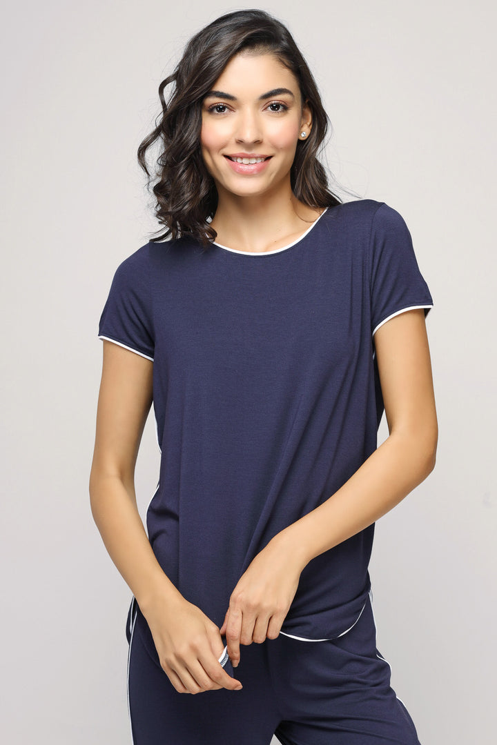 Model wearing Love Sleep Piping Pajamas Set in navy blue.