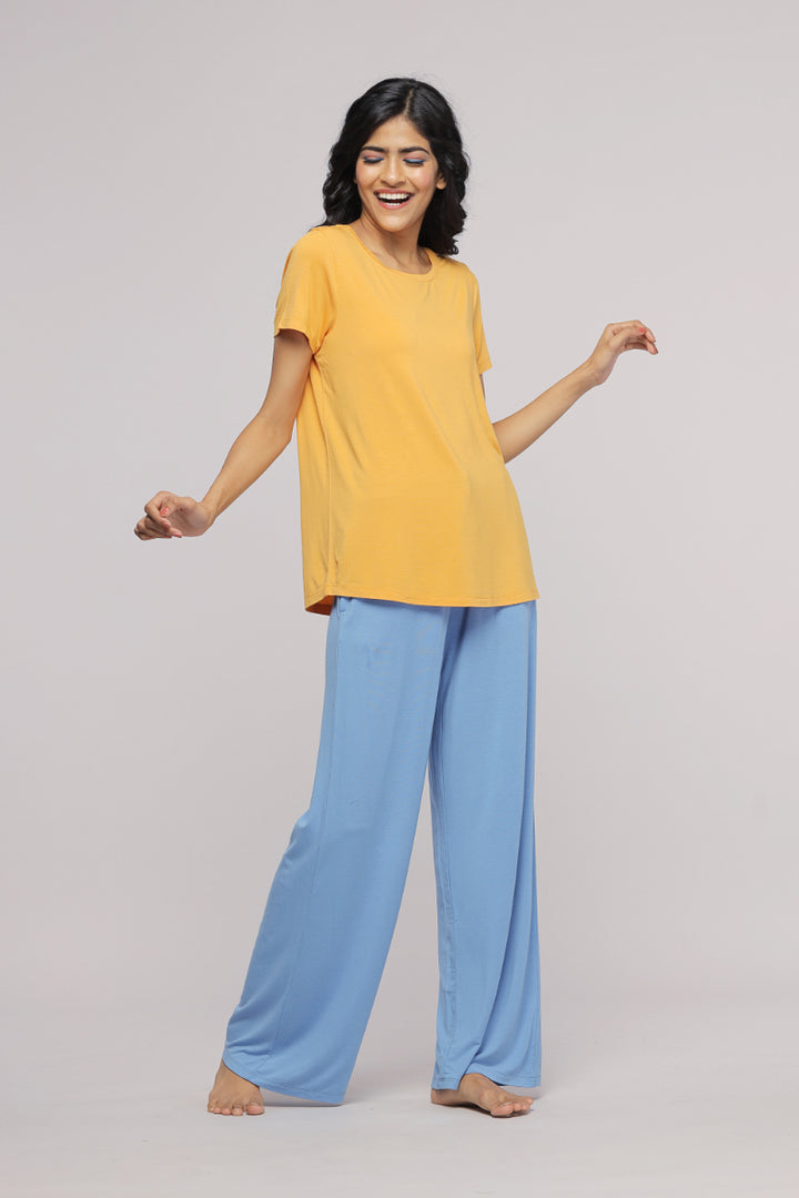 Cozy blue flared lounge pajama set with cheerful model.