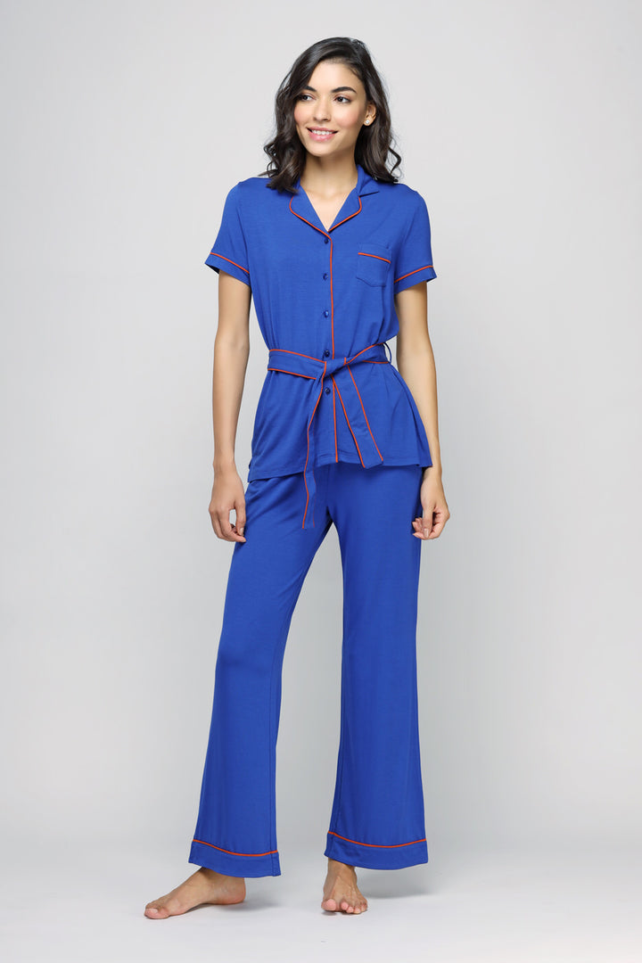 Perky blue flared pajamas set with red accents on a model.