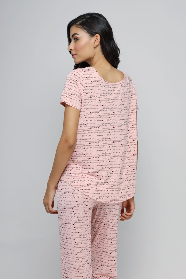 Pink cuff pajama set with heart print, perfect for cozy nights.