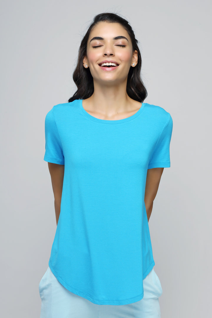 Smiling model wearing an effortless blue top for casual style.