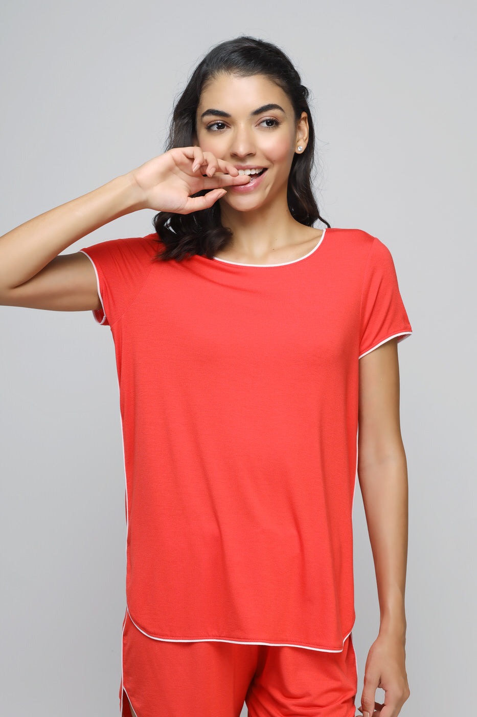 Model wearing Love Red Piping Shorts and matching top in vibrant red.