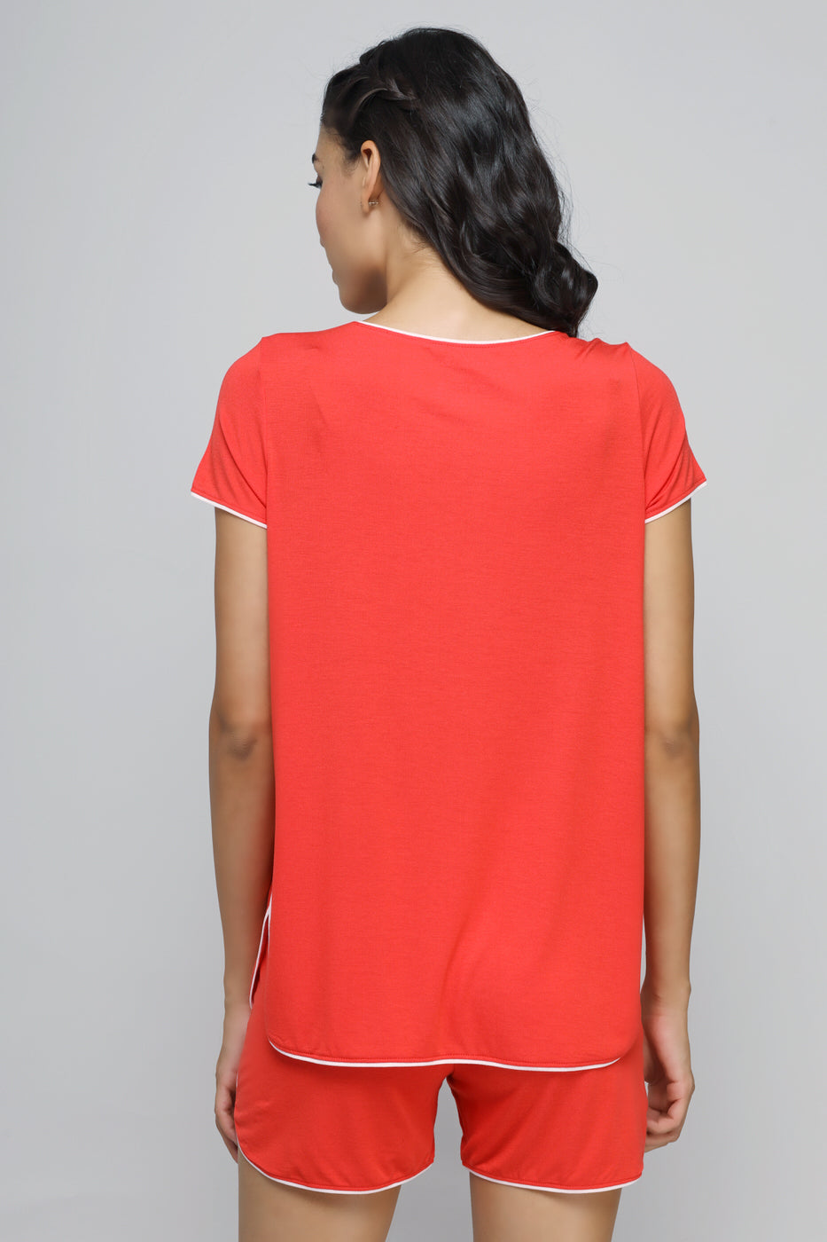 Woman wearing Love Red Piping Shorts and matching top, back view.