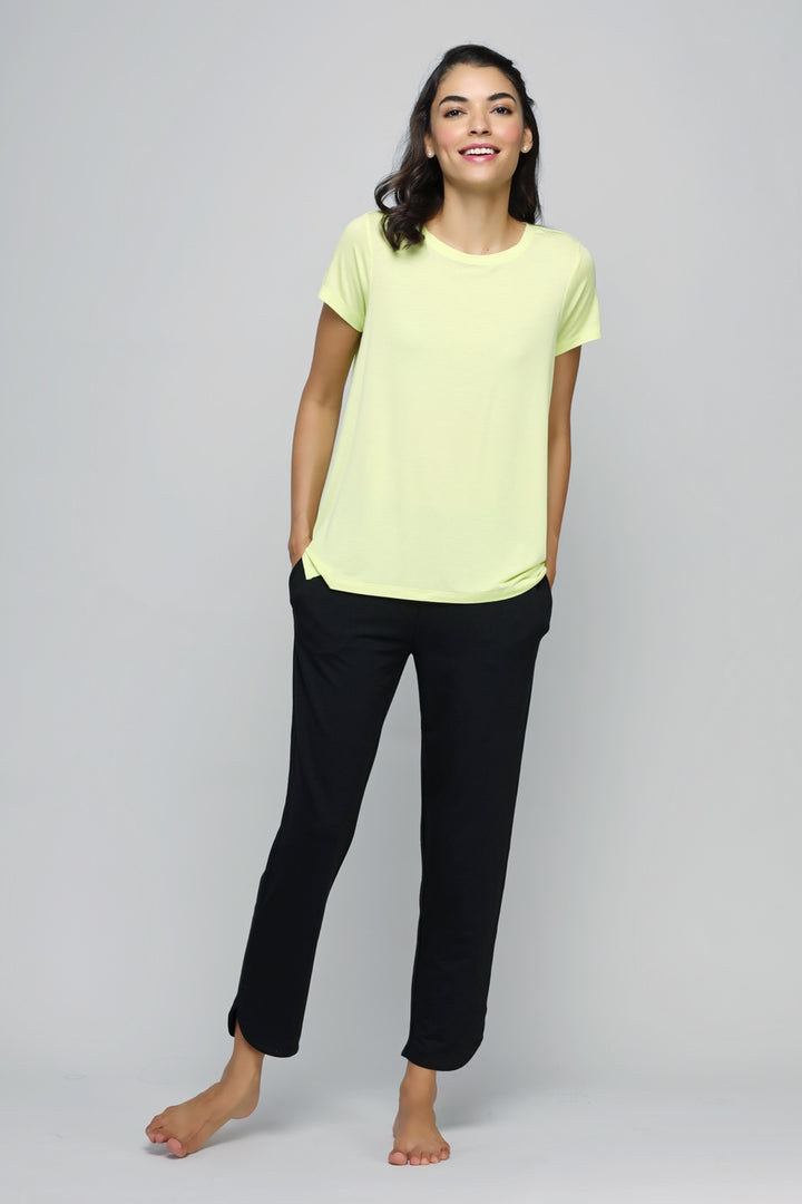 Bright yellow women's top paired with black pants, casual wear outfit.