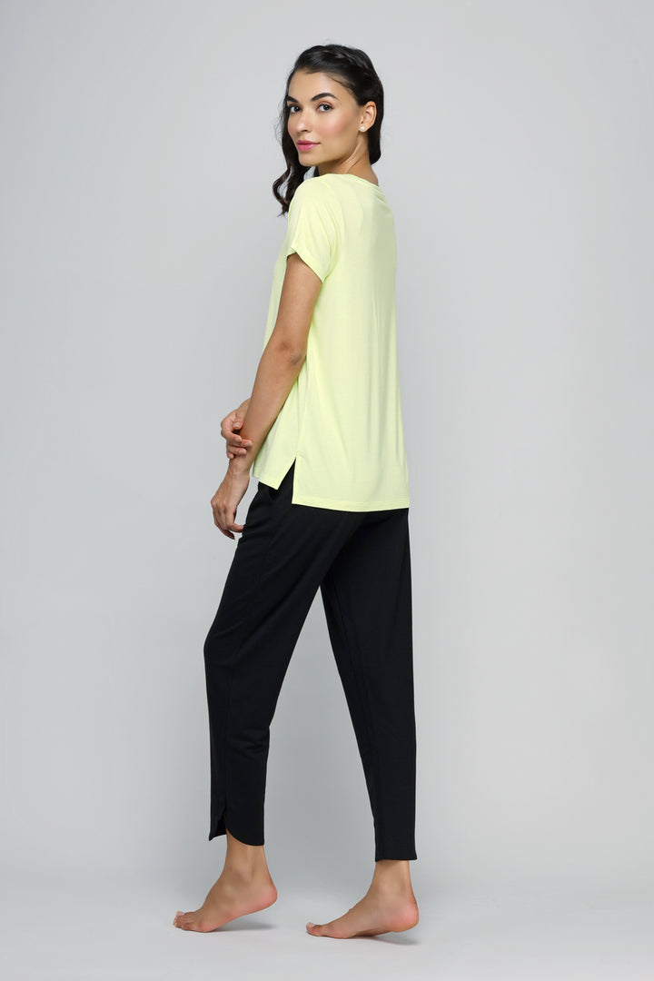 Woman wearing Rise And Run Top with stylish black pants.