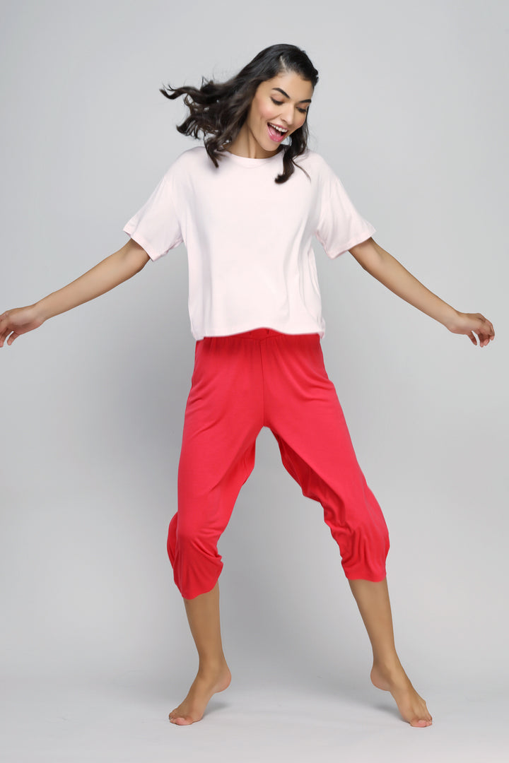 Smiling woman wearing Love Red Culottes with casual top and bare feet.