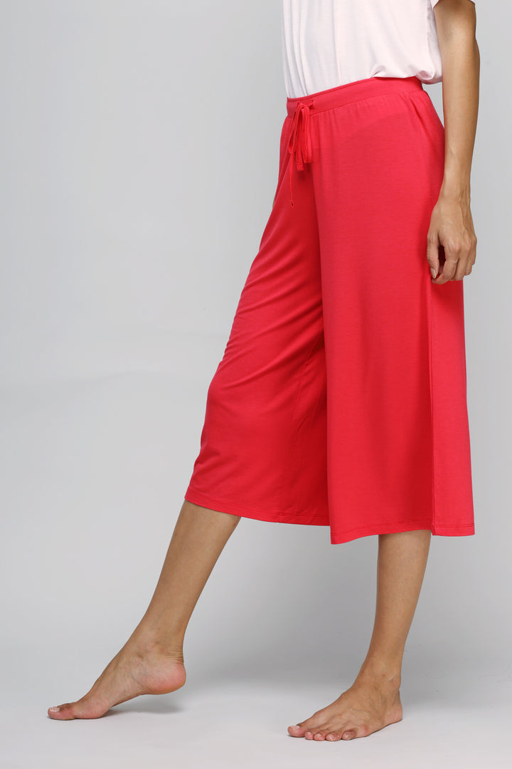 Woman wearing love red culottes with a stylish, comfortable design.