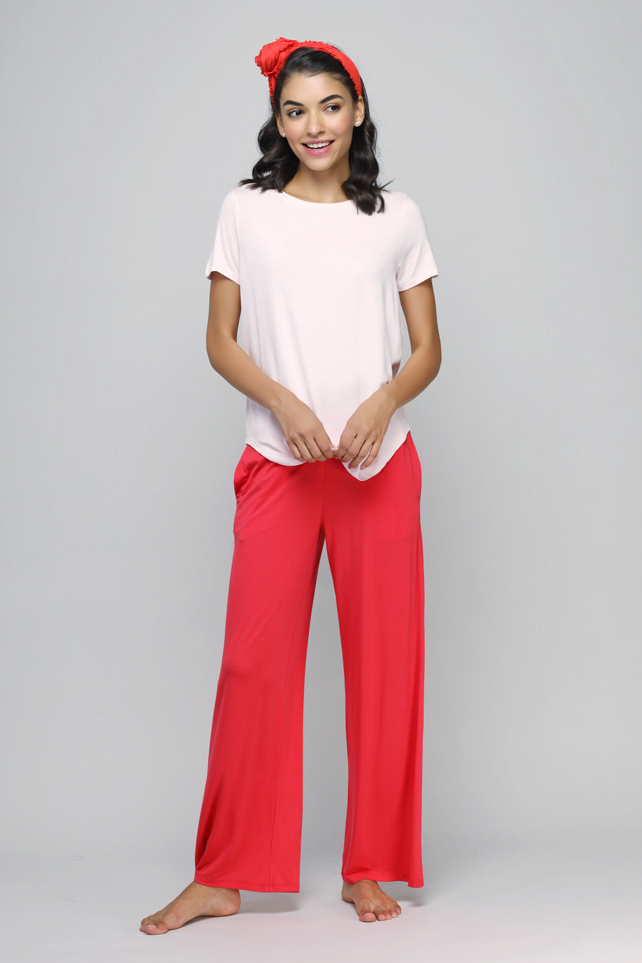 Woman in Love Red Flared Lounge Set with a pink top and red pants.