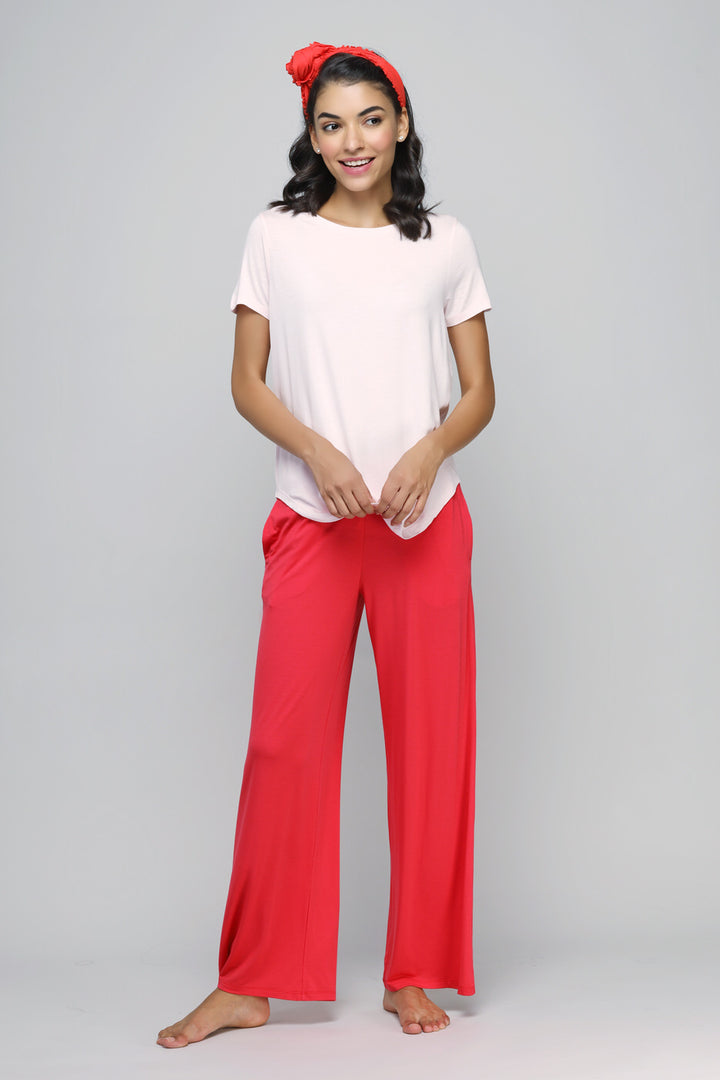 Woman in Love Red Flared Lounge Set with a pink top and red pants.