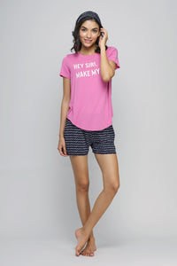 Hey Siri shorts set model in pink tee and patterned shorts.