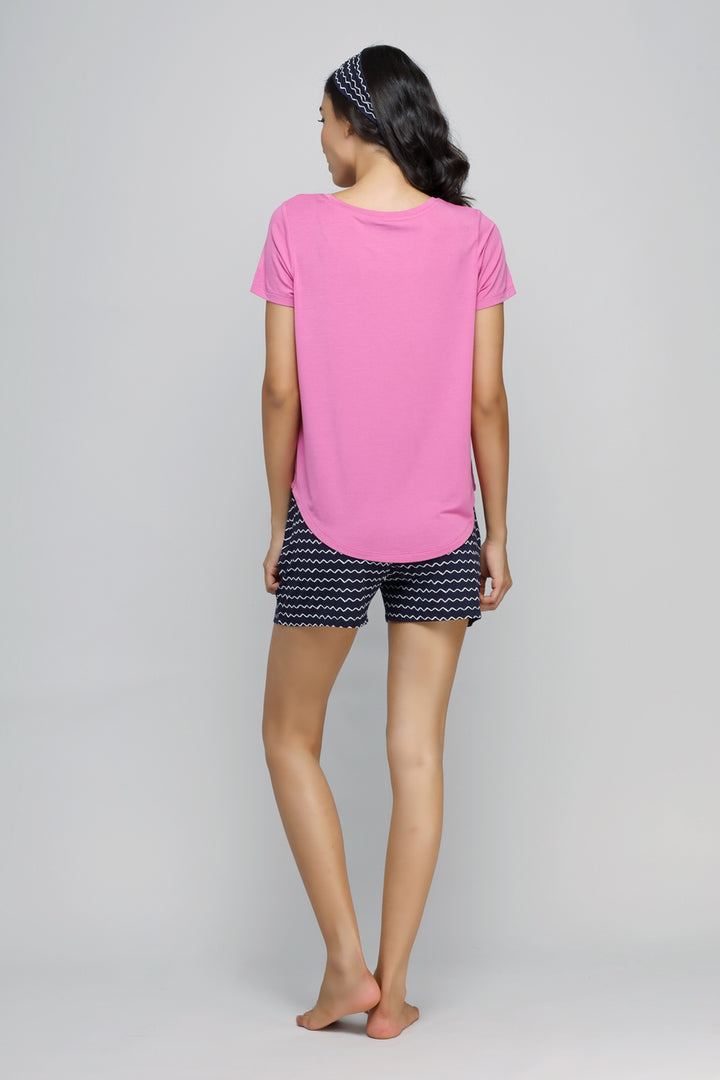 Back view of a woman wearing a pink Hey Siri Top.
