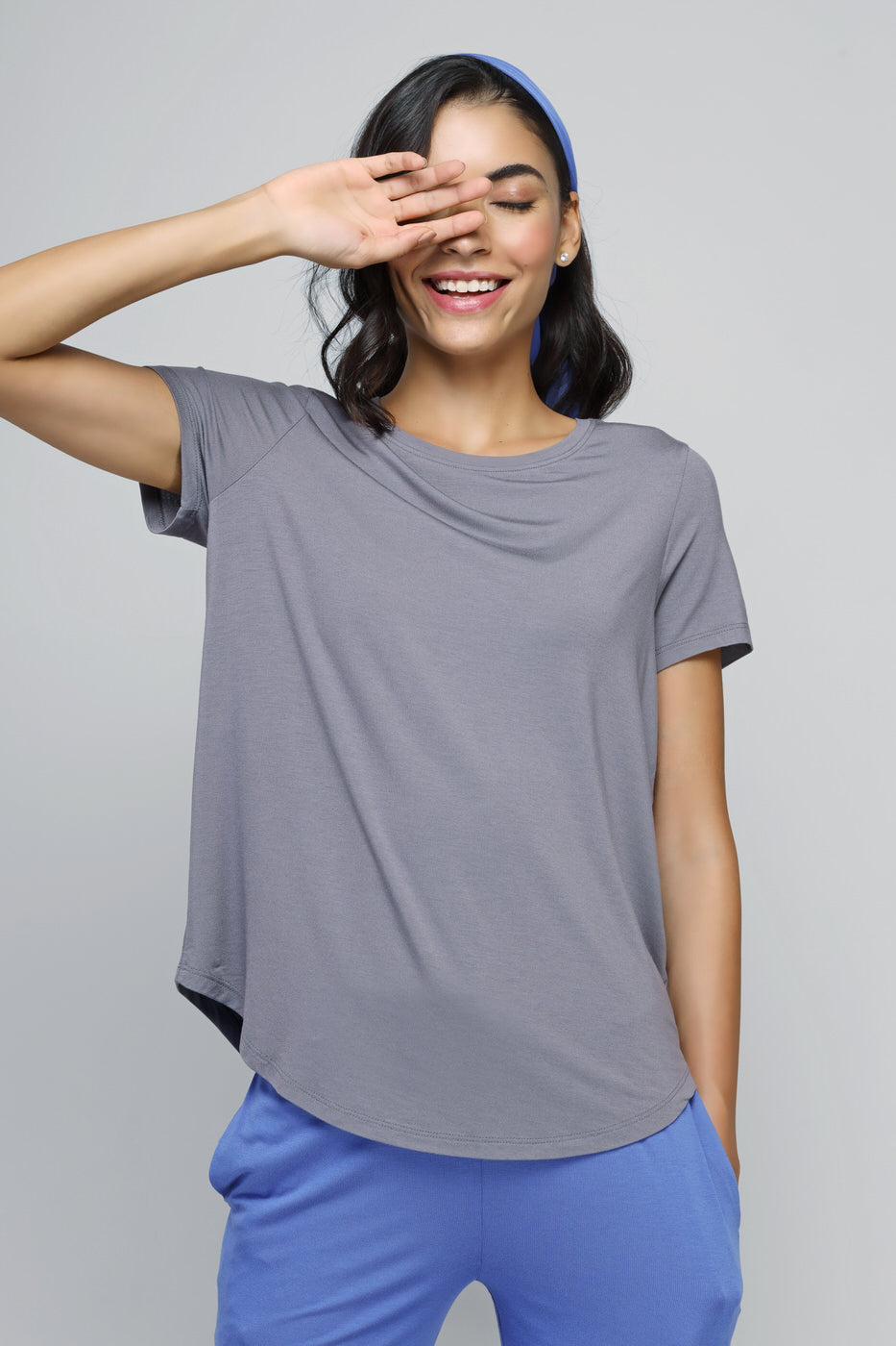 Relaxed blue straight lounge set model smiling in casual outfit.