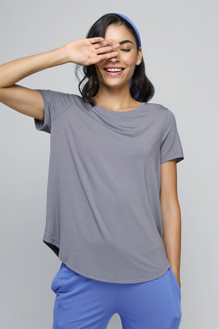Relaxed blue straight lounge set model smiling in casual outfit.