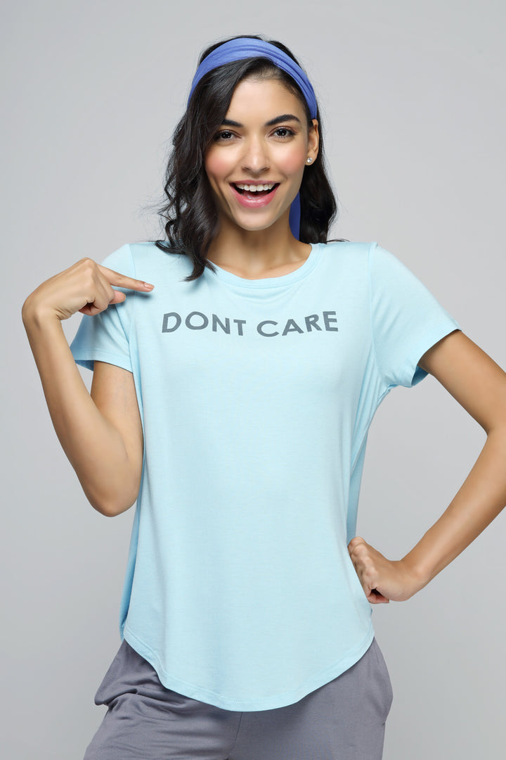 "Model wearing Wanderer Straight Lounge Set, light blue shirt, playful expression."