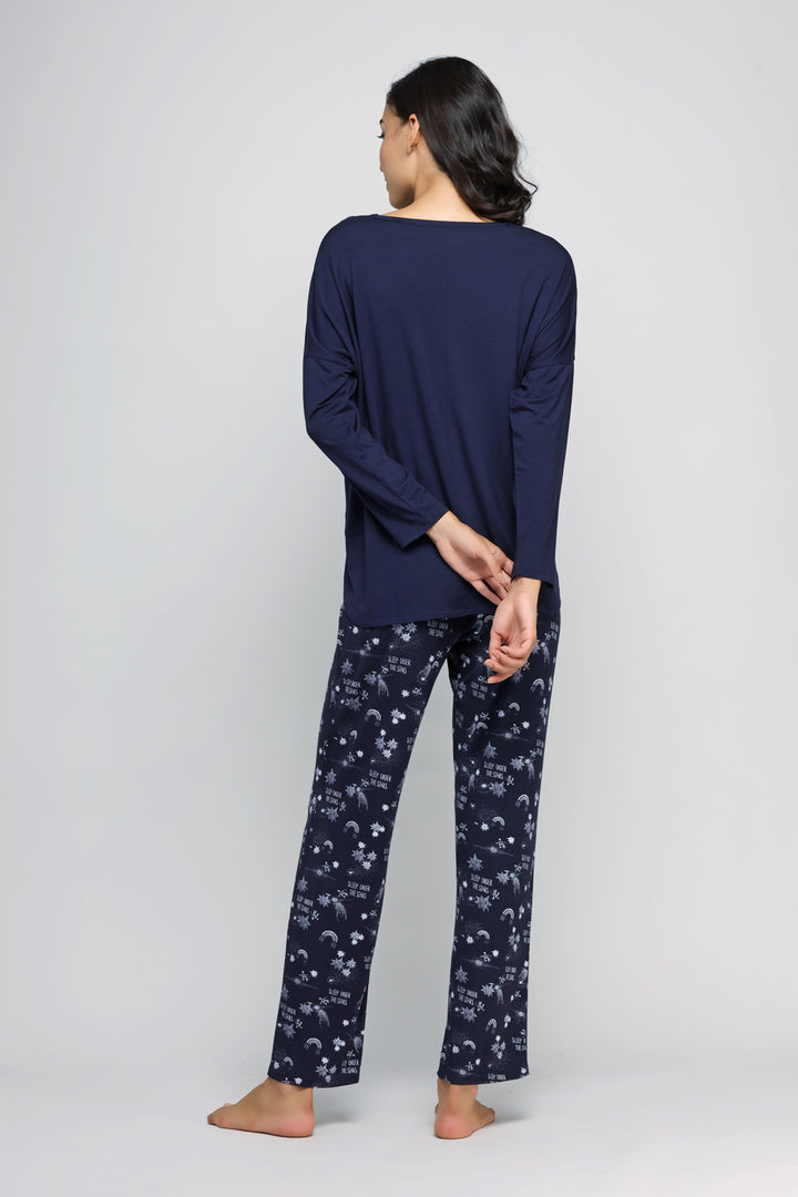 Model wearing Starry Night Pajama Set, featuring dark blue fabric with print.