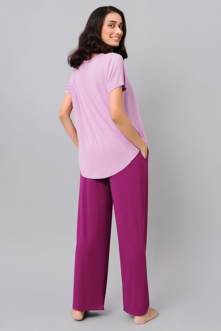 Model wearing a soothing purple top and matching pants.