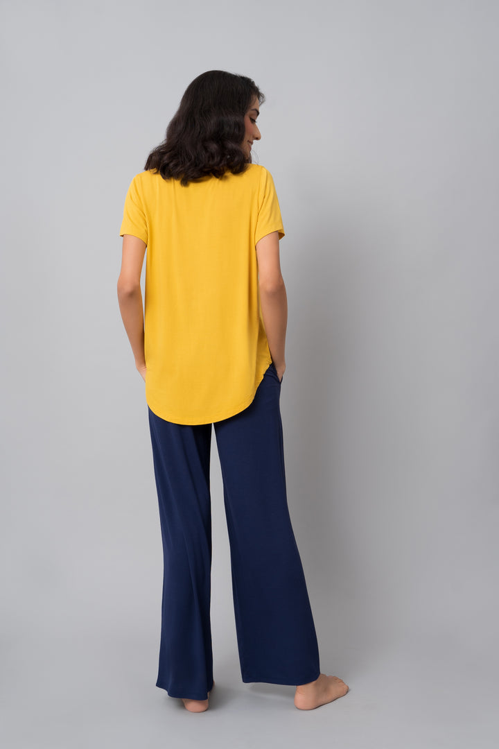Indigo flared lounge set featuring a yellow top and navy pants.
