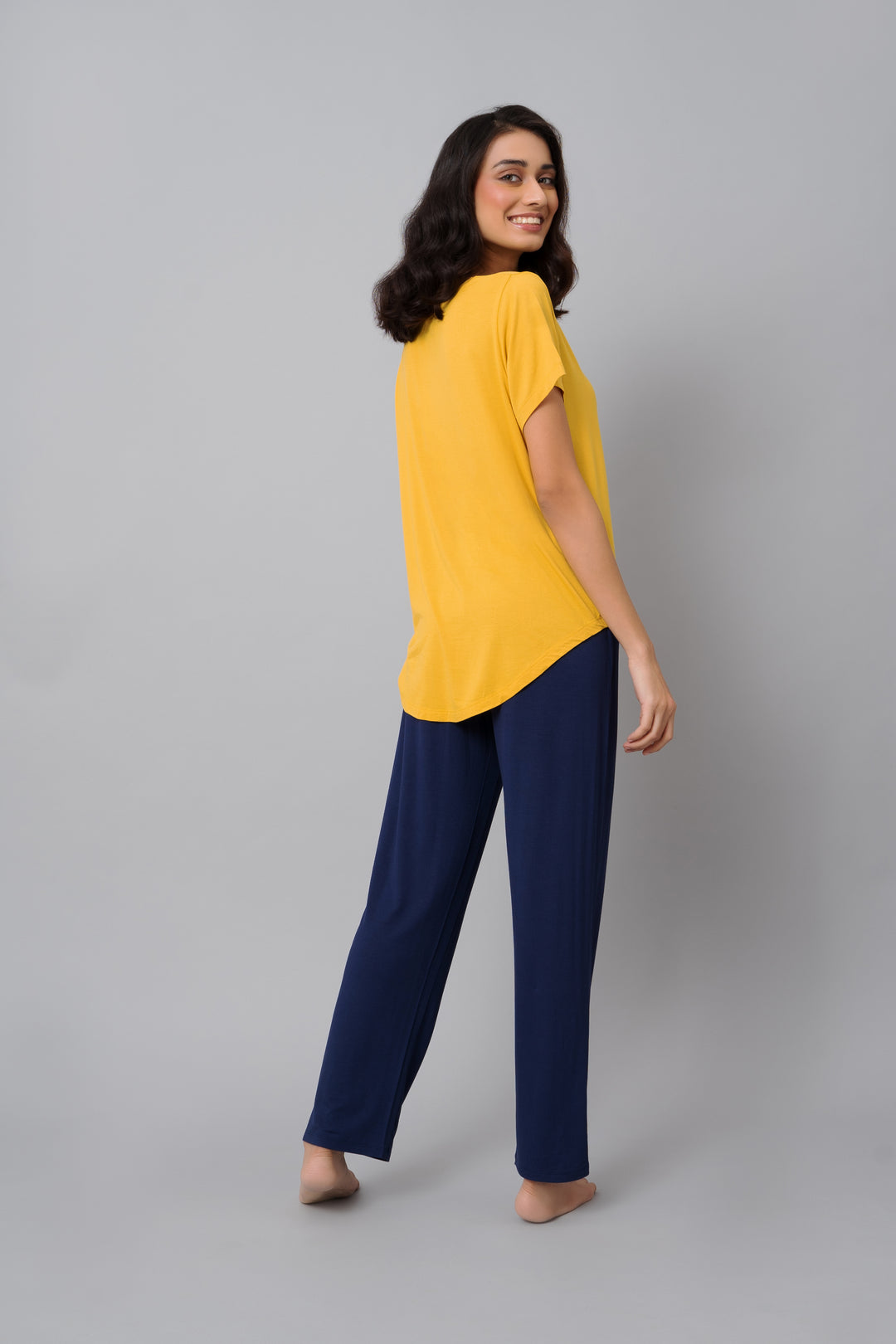 Model wearing Indigo Straight Lounge Set in yellow and navy.