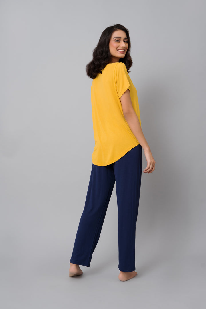 Model wearing Indigo Straight Lounge Set in yellow and navy.