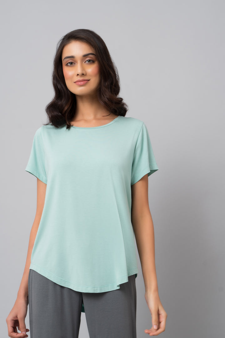 Woman wearing grey pearl straight lounge set with a mint green top.