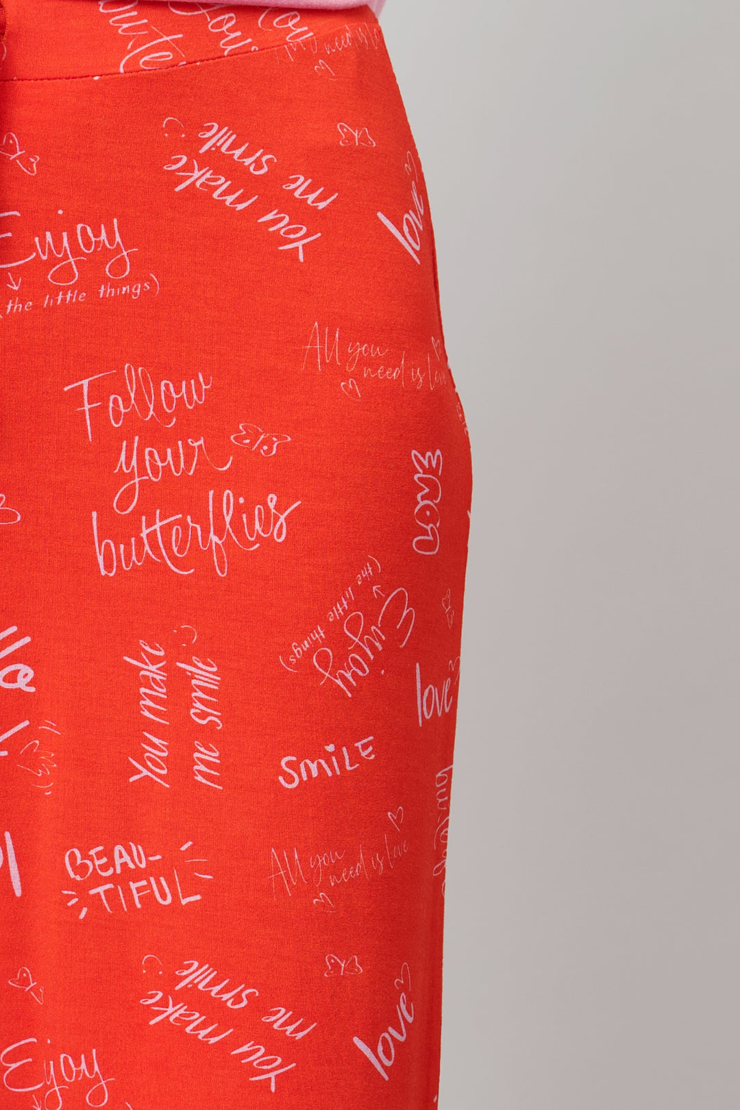 Love Escape Pajamas featuring colorful patterns with uplifting phrases.