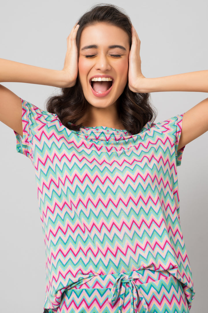 Model smiling in colorful Candy Stripes Shorts Set outfit.