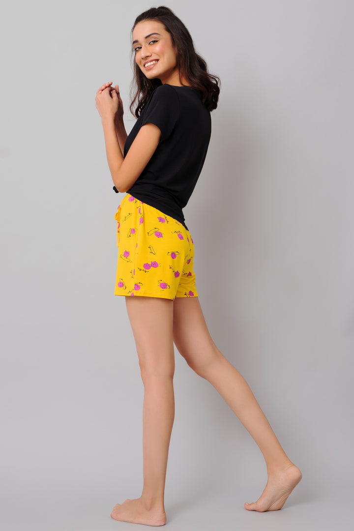 Model wearing Oh Happy Day Shorts Set, yellow shorts with floral design.
