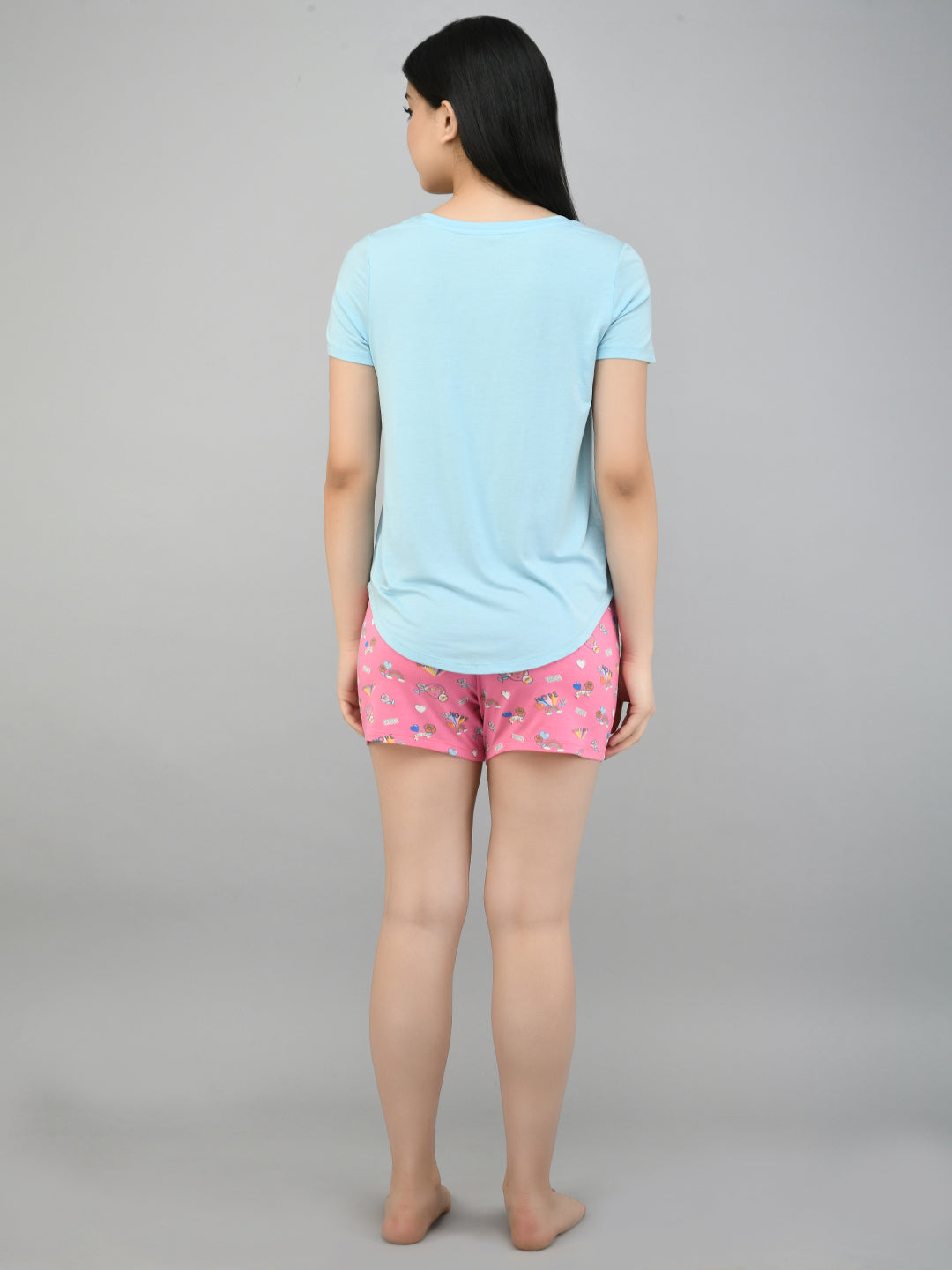 Back view of model wearing Summer Escape Shorts with light blue top.