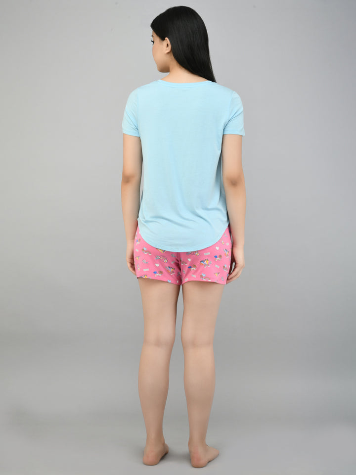 Back view of model wearing Summer Escape Shorts with light blue top.