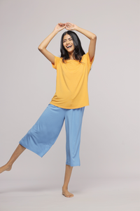 Smiling model wearing Horizon Blue Culotte Set, yellow top and blue culottes.