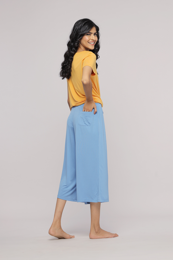 Model wearing Horizon Blue Culotte with a yellow top, stylish casual outfit.