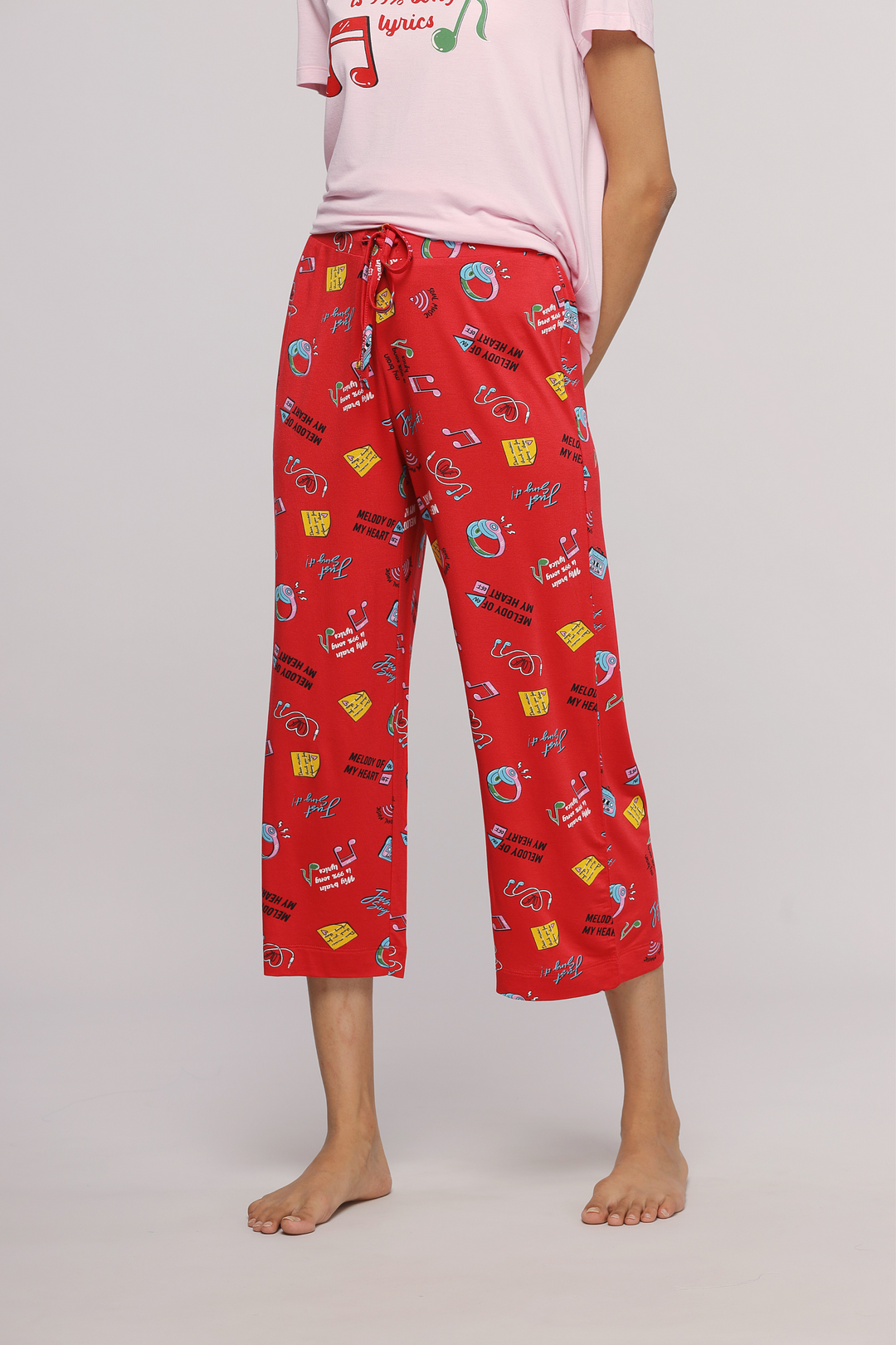 Colorful red capri pants with music-themed prints and comfortable fit.